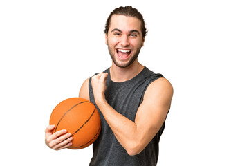 Obraz premium Young basketball player man over isolated background celebrating a victory