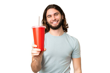 Young handsome man holding soda over isolated chroma key background with happy expression