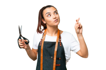 Seamstress woman over isolated chroma key background with fingers crossing and wishing the best