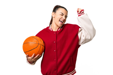 Young Woman playing basketball over isolated chroma key background celebrating a victory