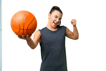Young beauty woman over isolated chroma key background playing basketball