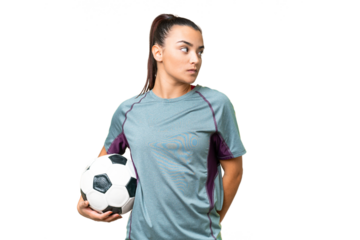 Young football player Woman over isolated chroma key background looking to the side