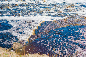 view of water flowing over stone shelf in waterfall