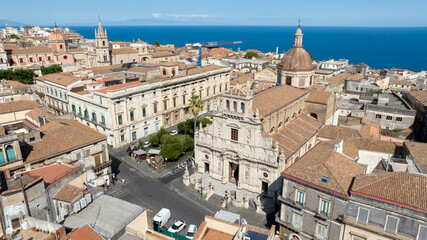 Obraz premium Aerial view of the Collegiate Basilica of San Sebastiano in Acireale. It's a Roman Catholic church in the city of Acireale in Sicily, in province of Catania, Italy. Mediterranean Sea is on the horizon