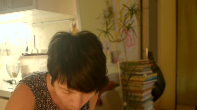 woman eating at desk surrounded by books and papers, quiet lunch scene in warm study light, reflective posture, focused
