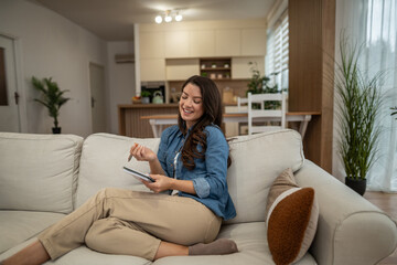 Obraz premium Young woman writing ideas in notebook at home