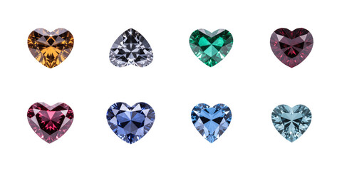 Collection of eight assorted colorful heart shaped faceted gemstones displayed against a black background on transparent background