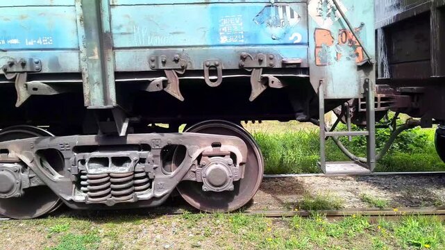 Old freight train moving slowly on railroad tracks