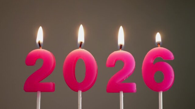 Close up of burning pink 2026 candles celebrating new year