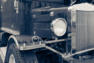 Close up front view of vintage road truck. Original design features a finely crafted chrome grille, elegant round headlights and other small details