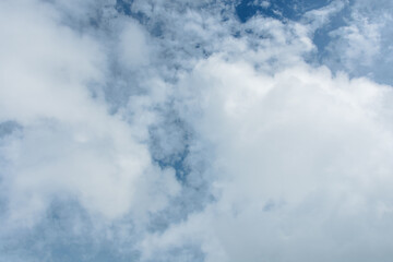 Fototapeta premium Blue Sky with Soft White Clouds Under Natural Daylight – High-Resolution Cloudscape Background for Nature, Weather, and Sky Photography