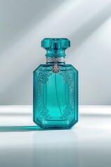 Luxurious teal glass perfume bottle with intricate engravings and silver detail