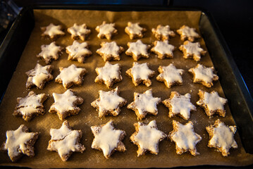 Batch of freshly baked christmas cookies on a baking sheet