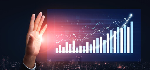 A hand interacts with a transparent digital screen displaying graphs and charts, symbolizing financial success and urban innovation at night. Impute