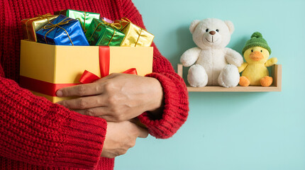 a person in a red sweater holding a yellow gift box with colorful wrapped chocolates. 