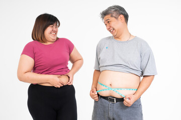 Embracing the Journey: A couple shares a lighthearted moment, measuring their waists, symbolizing their shared commitment to a healthier lifestyle and mutual encouragement.