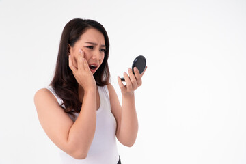 Mirror Reflection Concern: A woman stares at a mirror, her expression revealing deep concern, perhaps at an unexpected sight.