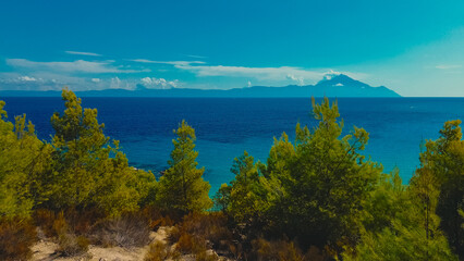 Fototapeta premium Amazing Kavourotripes Beach in Sithonia peninsula, Halkidiki, Greece. Fly along lagoon with turquoise water, sandy beach and pine trees. Beautiful Paradise beach Kavourotripes