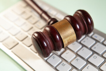 keyboard with law gavel on laptop, closeup