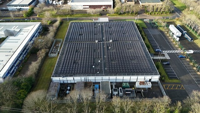 Aerial drone view of large scale cutting-edge technology and futuristic infrastructure of a large-scale data center in Milton Keynes, UK. AI cloud quantum computing.  - Powered by Adobe