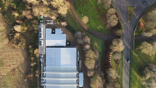 Aerial drone view of large scale cutting-edge technology and futuristic infrastructure of a large-scale data center in Milton Keynes, UK. AI cloud quantum computing.  - Powered by Adobe