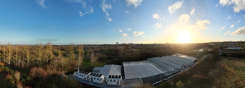 Aerial drone view of large scale cutting-edge technology and futuristic infrastructure of a large-scale data center in Milton Keynes, UK. AI cloud quantum computing. - Powered by Adobe