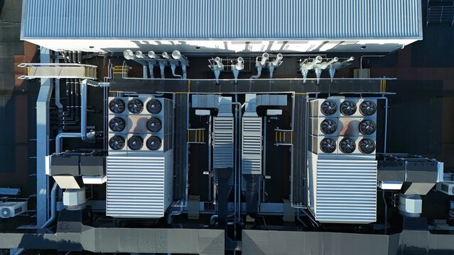 Aerial drone top down rotating view of cooling and ventilation systems on a data storage center warehouse building showing modern infrastructure.