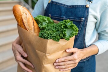 grocery shopper hold paper bag with bread and vegetable