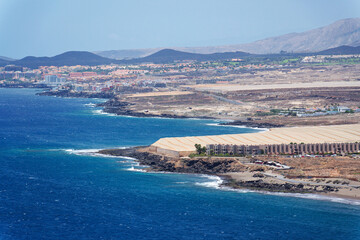 Greenhouses on coast near Tenerife airport, sunny summer day, Canary Islands, Spain