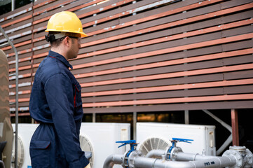 A chief maintenance worker is inspecting the high-pressure water pump system of an industrial plant...