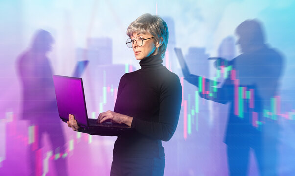 Business, financial analytics. Senior businesswoman works on a laptop, analyzing market charts and digital data trends, making strategic decisions in a fast-paced corporate environment. - Powered by Adobe