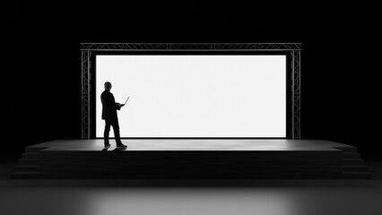 Presentation setup and digital content control performed by a professional with a laptop on a stage facing a large screen. Event production, keynote preparation, visual communication