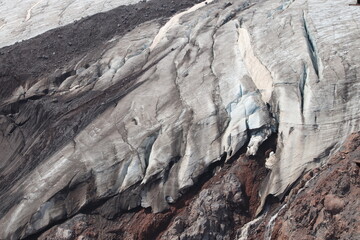 A cracked glacier on the slopes of Elbrus on a summer day