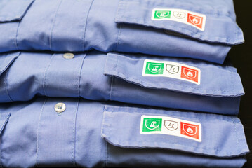 Protective work shirts with fire resistant, chemical and antistatic safety pictograms