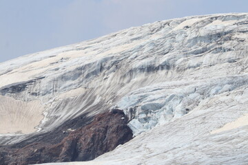 A cracked glacier on the slopes of Elbrus on a summer day
