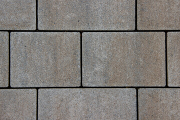 Obraz premium Textured gray paving stones arranged in a neat pattern, showcasing the durable surface and design elements of outdoor flooring for landscaping and construction projects