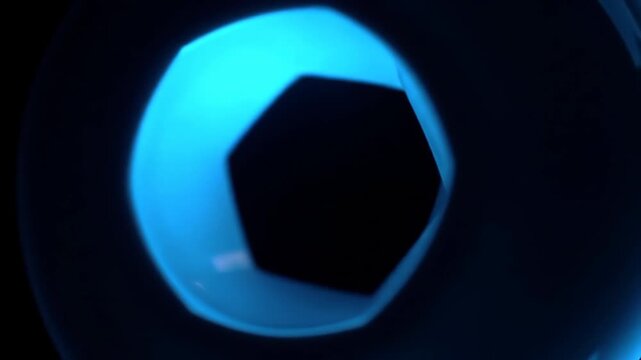 Abstract glowing blue light with a hexagonal dark space, on a black background