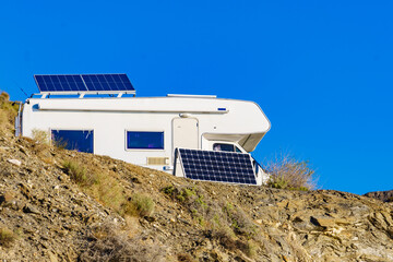 Caravan with tilt solar panels on roof.