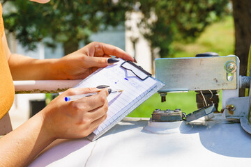 Woman checking level of propane gas in tank