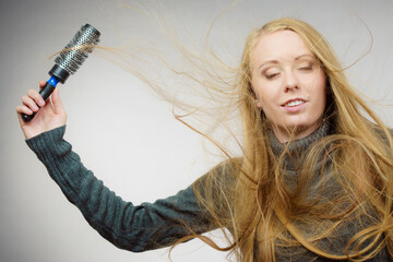 Girl styling her long hair
