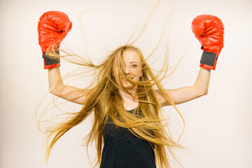 Woman in red gloves with arms up