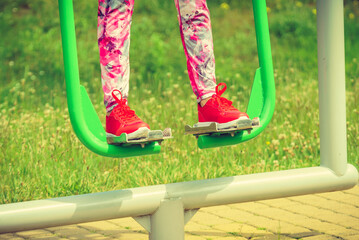 Girl doing legs exercises in outdoor gym