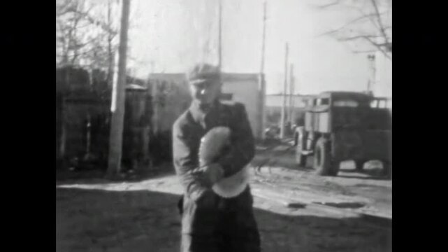 Male workers at work in woodworking industry stand in industrial outdoor. Man carrying and handling timber. Manual labor in wood processing. Old woodworking film. Archival retro 1960s. Vintage archive