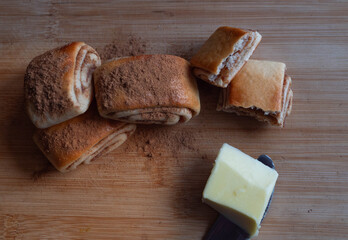 Top down shot of Freshly baked cinnamon rolls dusted with spice and a butterknife