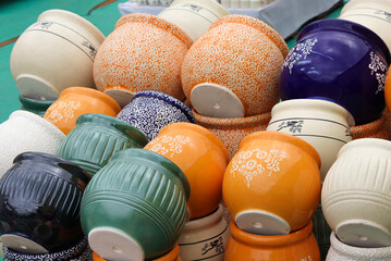 A Collection of flower Pots or containers painted in vibrant colors, porcelain, China, handmade, clay art, pottery, design, pattern, culture of India.