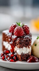 Indulge in a rich slice of dark chocolate cake, layered with creamy filling, drizzled with pomegranate jam and adorned with fresh raspberries, perfect for a sweet treat any time of day