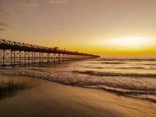 Summer sunset at the port of Pimentel, with a view of the pier in Chiclayo, Lambayeque, on the Peruvian coast