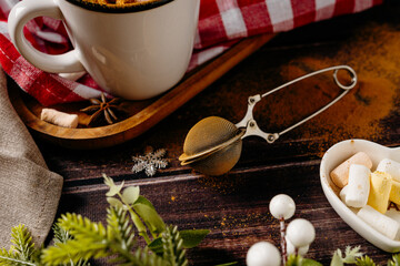 Close up winter still life with hot drink, cookies and festive details. Cozy home atmosphere and seasonal comfort concept.