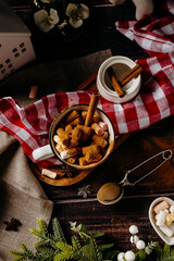 Vertical cozy winter flat lay with cookies, cocoa and festive decor. Warm holiday mood and rustic home comfort concept.