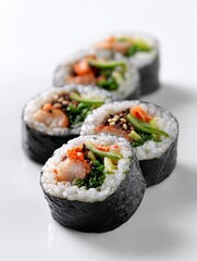 Closeup of assorted sushi rolls with vegetables and seafood on white plate